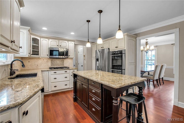 9210 Via Cimato Dr, Clarence, NY 14032 - kitchen with stainless steel appliances, a breakfast bar area, a chandelier, dark brown cabinetry, and tasteful backsplash