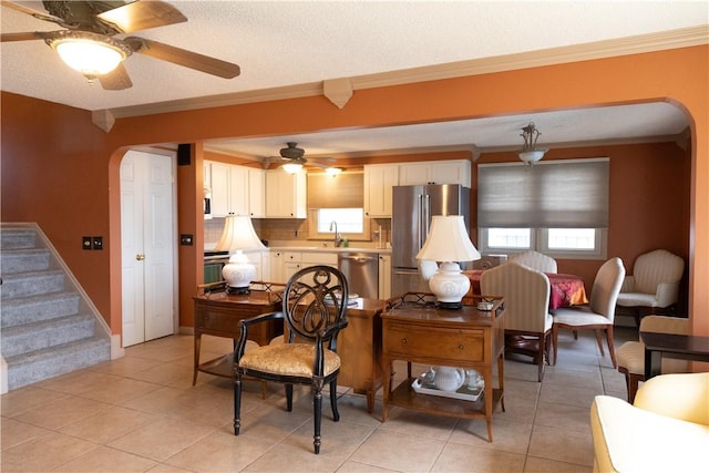 1602 Edgemere Dr, Greece, NY 14612 - living room with arched walkways, ceiling fan, healthy amount of natural light, ornamental molding, and stairs
