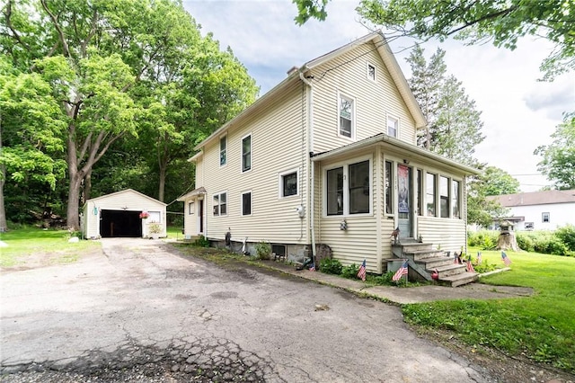 290 N Main St, Warsaw, NY 14569 - view of front of house featuring entry steps, an outbuilding, a garage, and a front lawn