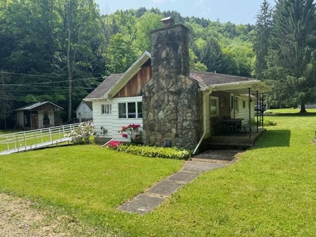 3627 Irish Ave Unit B, Willing, NY 14895 - view of side of home featuring a chimney, a porch, and a view of trees