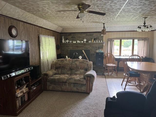 3627 Irish Ave Unit B, Willing, NY 14895 - living room with wooden walls, a ceiling fan, and a fireplace