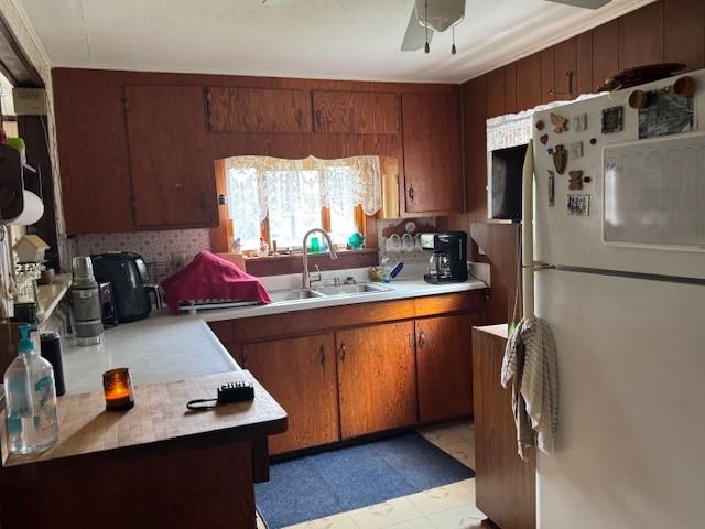 3627 Irish Ave Unit B, Willing, NY 14895 - kitchen with freestanding refrigerator, light countertops, brown cabinetry, and backsplash