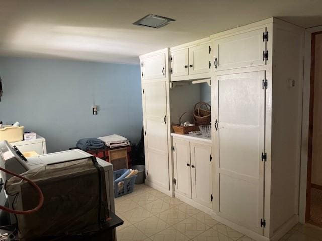 3627 Irish Ave Unit B, Willing, NY 14895 - kitchen with washing machine and dryer, white cabinets, and light floors