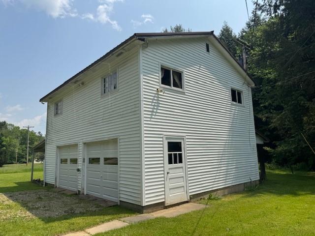 3627 Irish Ave Unit B, Willing, NY 14895 - view of side of property featuring a lawn, an attached garage, and driveway