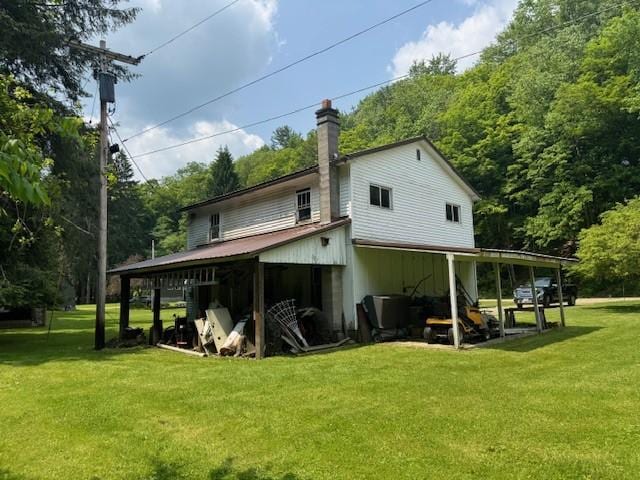 3627 Irish Ave Unit B, Willing, NY 14895 - rear view of house with a yard, a chimney, and a view of trees