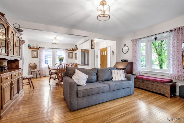 87 Pasadena Pl, Amherst, NY 14221 - living room with light wood-style flooring and a chandelier