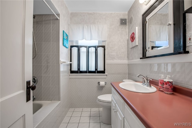 87 Pasadena Pl, Amherst, NY 14221 - bathroom featuring tile patterned floors, vanity, tub / shower combination, tile walls, and a wainscoted wall