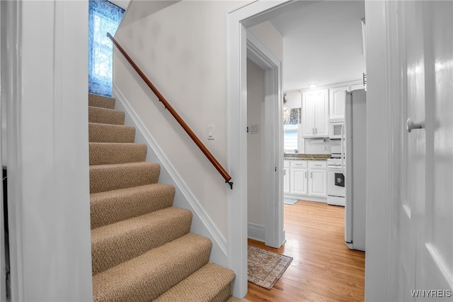 87 Pasadena Pl, Amherst, NY 14221 - stairs featuring wood finished floors and baseboards