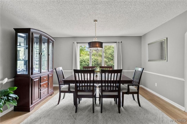 13 Thames Ct, Amherst, NY 14221 - dining space with light wood-style flooring and a textured ceiling