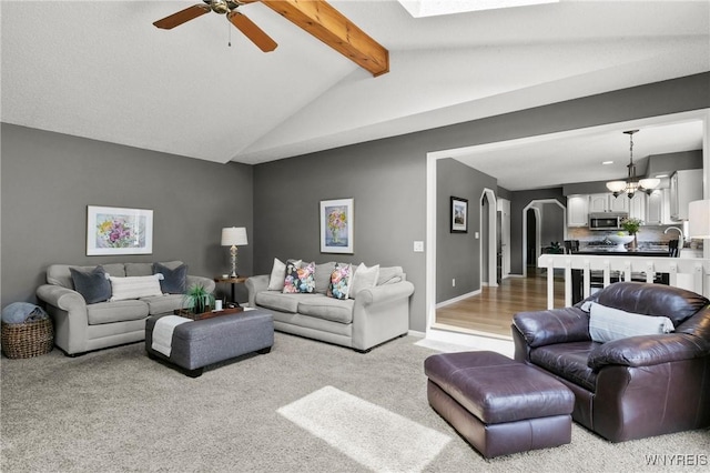 13 Thames Ct, Amherst, NY 14221 - living area featuring carpet, a chandelier, ceiling fan, and arched walkways