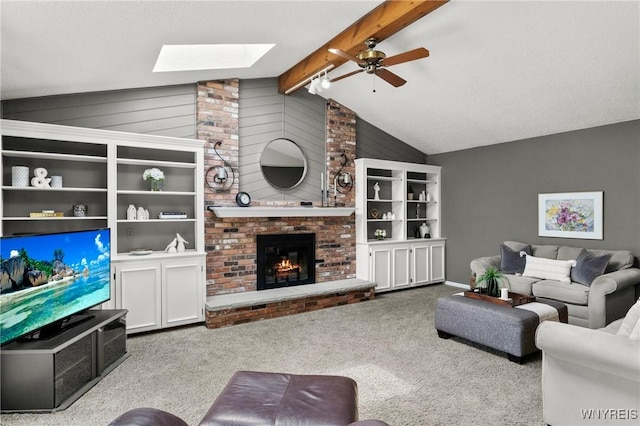 13 Thames Ct, Amherst, NY 14221 - carpeted living room featuring a skylight, ceiling fan, and a fireplace
