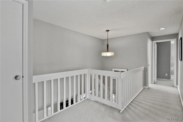 13 Thames Ct, Amherst, NY 14221 - hall featuring an upstairs landing, carpet flooring, and a textured ceiling
