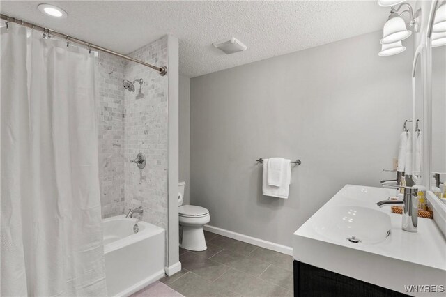 13 Thames Ct, Amherst, NY 14221 - full bathroom with shower / bath combo with shower curtain, double vanity, tile patterned floors, and a textured ceiling