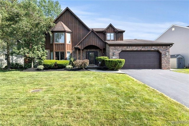 13 Thames Ct, Amherst, NY 14221 - view of front of house with driveway, a garage, a front yard, and a storage unit