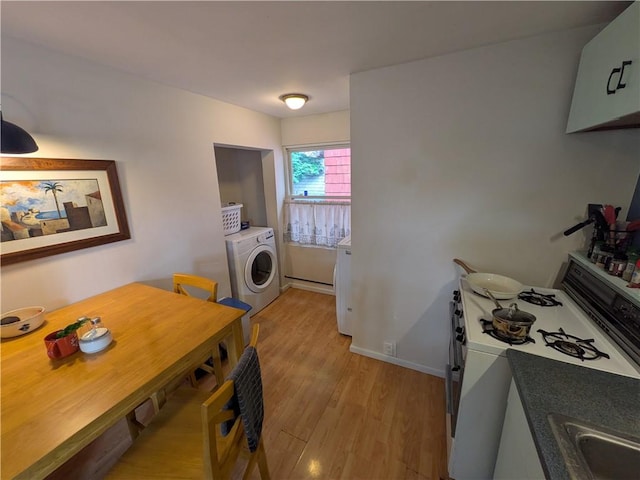 21 Charlotte Ave, Bradford City, PA 16701 - kitchen with washer / clothes dryer, white gas stove, and light wood-style floors