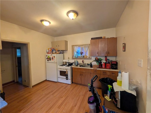 21 Charlotte Ave, Bradford City, PA 16701 - kitchen featuring white appliances, light wood finished floors, light countertops, and brown cabinetry