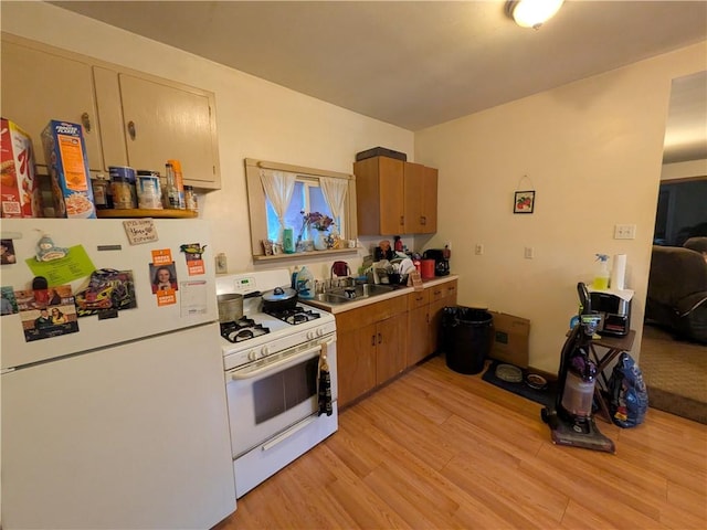 21 Charlotte Ave, Bradford City, PA 16701 - kitchen with white appliances, light wood-style flooring, brown cabinetry, and light countertops