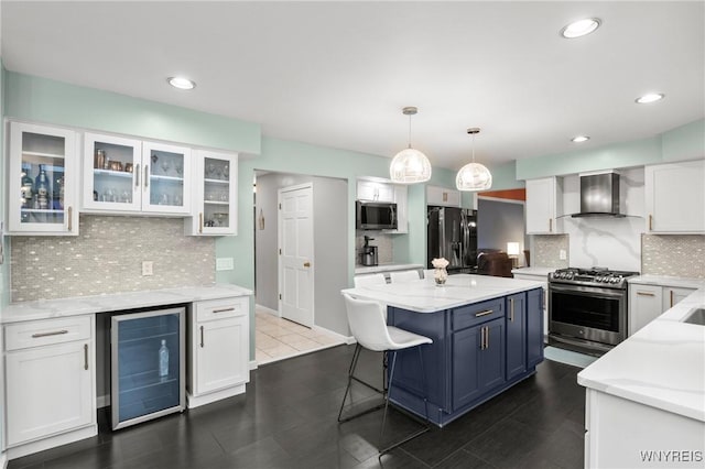 5103 Eastbrooke Pl, Clarence, NY 14221 - kitchen with wall chimney range hood, stainless steel appliances, wine cooler, white cabinetry, and a center island