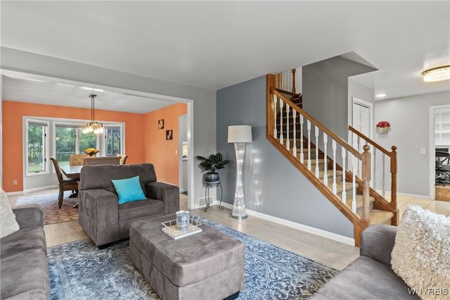 5103 Eastbrooke Pl, Clarence, NY 14221 - living area featuring stairs, wood finished floors, and a chandelier