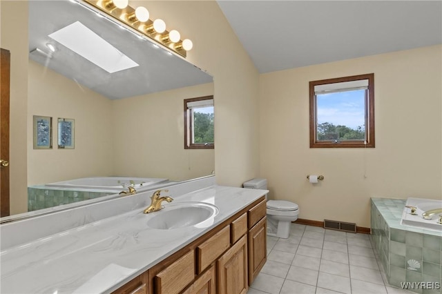 5103 Eastbrooke Pl, Clarence, NY 14221 - bathroom featuring vaulted ceiling, a skylight, vanity, a garden tub, and tile patterned floors
