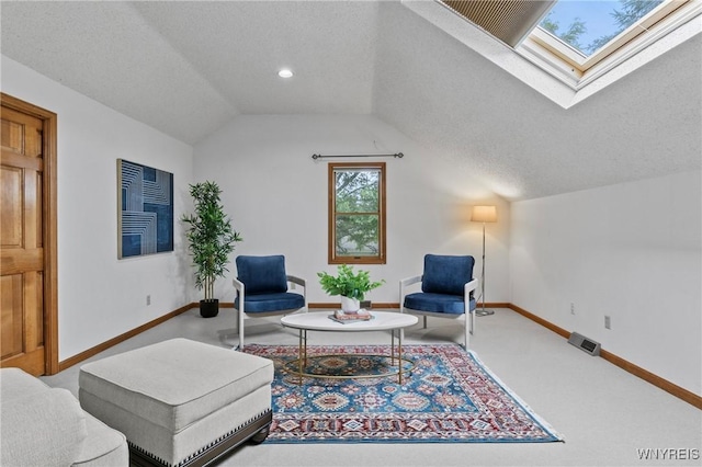 5103 Eastbrooke Pl, Clarence, NY 14221 - living area featuring a skylight, vaulted ceiling, a textured ceiling, and carpet floors