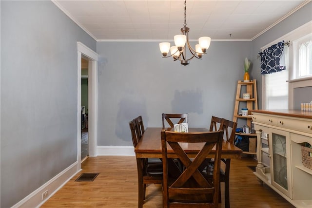109 Oakwood Ave, Elmira, NY 14903 - dining area featuring a chandelier, wood finished floors, and crown molding