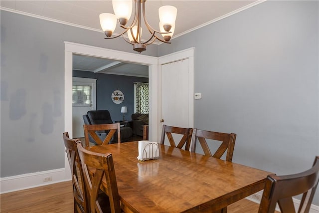 109 Oakwood Ave, Elmira, NY 14903 - dining area with a chandelier, wood finished floors, and ornamental molding
