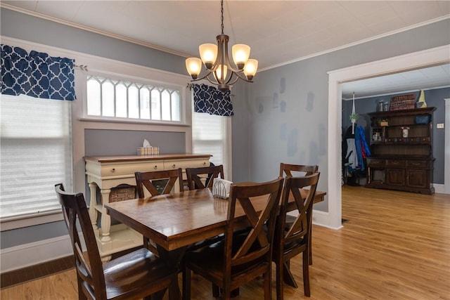 109 Oakwood Ave, Elmira, NY 14903 - dining space with a chandelier, crown molding, and light wood finished floors