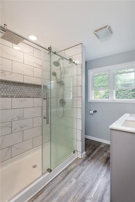 109 Oakwood Ave, Elmira, NY 14903 - full bathroom featuring a stall shower, wood finished floors, and vanity