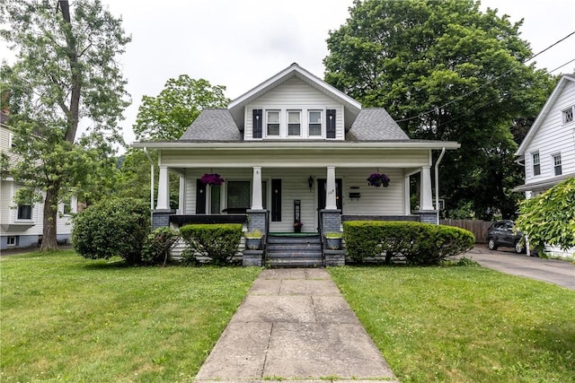 109 Oakwood Ave, Elmira, NY 14903 - bungalow-style house featuring a porch, a front lawn, and a shingled roof