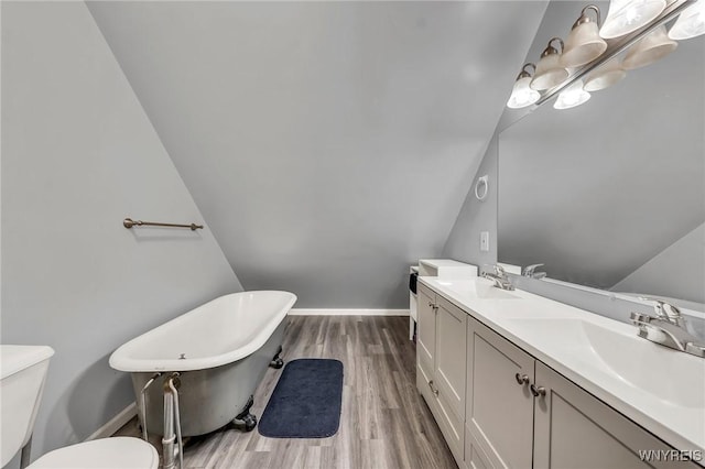 295 Continental Dr, Lockport City, NY 14094 - bathroom with a freestanding bath, wood finished floors, and double vanity