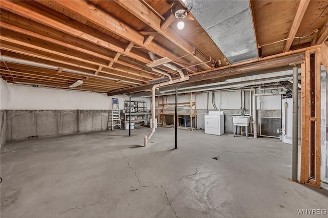 295 Continental Dr, Lockport City, NY 14094 - unfinished below grade area featuring washer / dryer and gas water heater