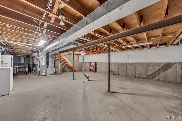 295 Continental Dr, Lockport City, NY 14094 - unfinished basement with stairway, heating unit, and washer / dryer