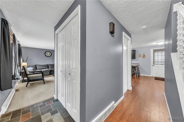 295 Continental Dr, Lockport City, NY 14094 - hall with a textured ceiling and baseboards