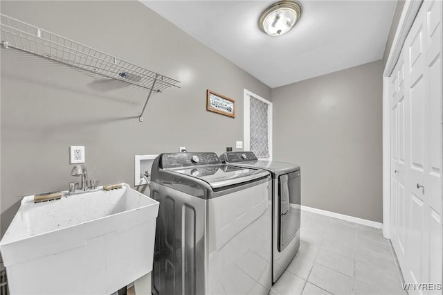 295 Continental Dr, Lockport City, NY 14094 - laundry area featuring separate washer and dryer and light tile patterned floors