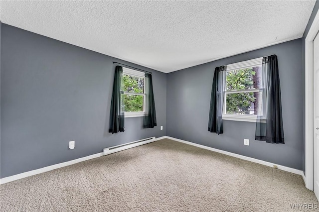 295 Continental Dr, Lockport City, NY 14094 - empty room featuring a baseboard heating unit, a textured ceiling, and carpet flooring
