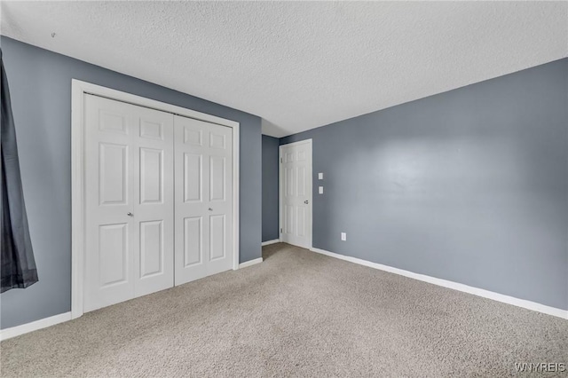 295 Continental Dr, Lockport City, NY 14094 - unfurnished bedroom featuring carpet, a closet, and a textured ceiling