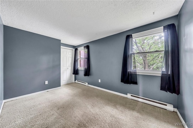 295 Continental Dr, Lockport City, NY 14094 - carpeted spare room with a baseboard heating unit and a textured ceiling