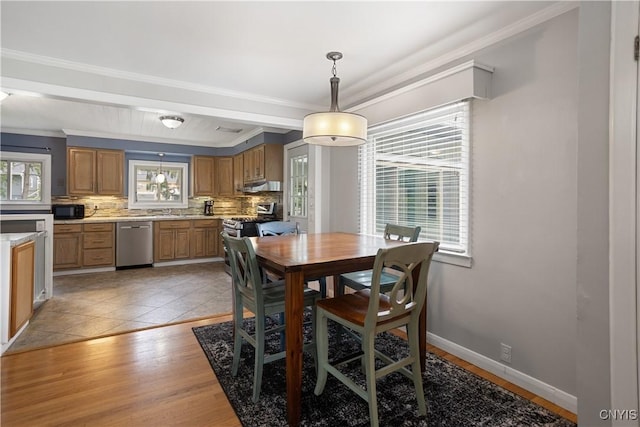 129 Butternut Dr, Dewitt, NY 13214 - dining room featuring healthy amount of natural light, crown molding, and light wood-type flooring