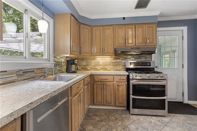 129 Butternut Dr, Dewitt, NY 13214 - kitchen featuring stainless steel appliances, under cabinet range hood, decorative backsplash, light countertops, and brown cabinetry