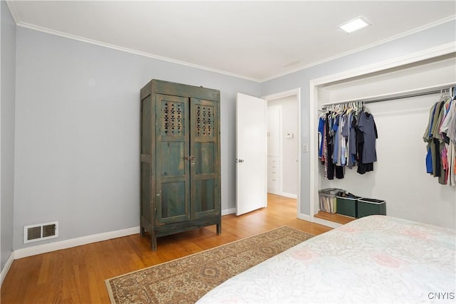 129 Butternut Dr, Dewitt, NY 13214 - bedroom featuring wood finished floors, a closet, and ornamental molding