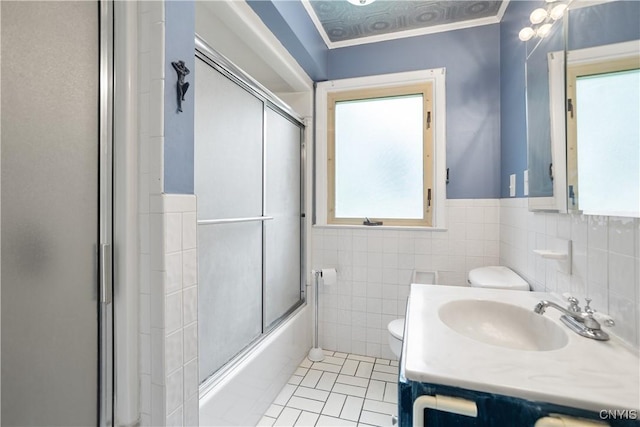 129 Butternut Dr, Dewitt, NY 13214 - bathroom with vanity, tile walls, a wainscoted wall, shower / bath combination with glass door, and tile patterned floors