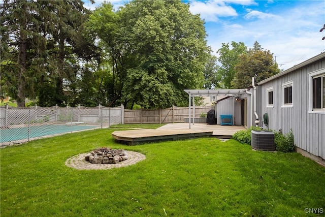 129 Butternut Dr, Dewitt, NY 13214 - fenced backyard with a wooden deck, a fire pit, and a pergola