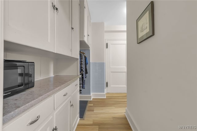 33 Gates Cir Unit 6B, Buffalo, NY 14222 - hall featuring light wood-style floors and baseboards