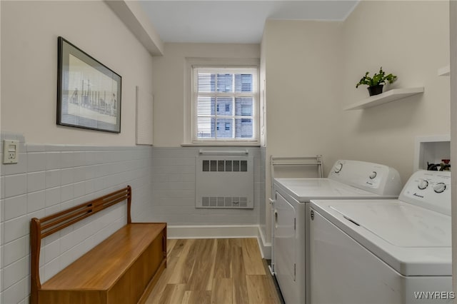 33 Gates Cir Unit 6B, Buffalo, NY 14222 - laundry room with washer and dryer, light wood-style floors, radiator heating unit, and a wainscoted wall