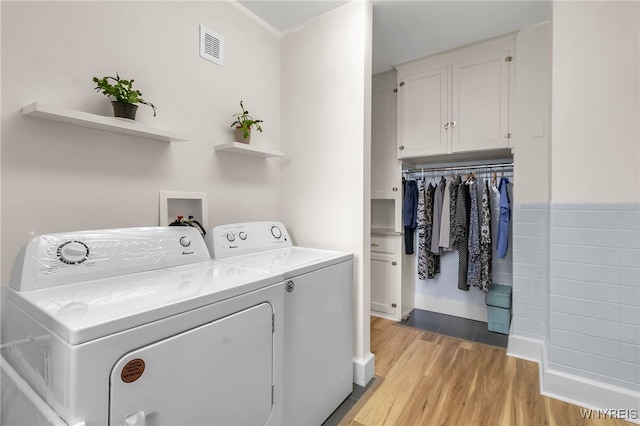 33 Gates Cir Unit 6B, Buffalo, NY 14222 - laundry area with washing machine and clothes dryer and light wood finished floors