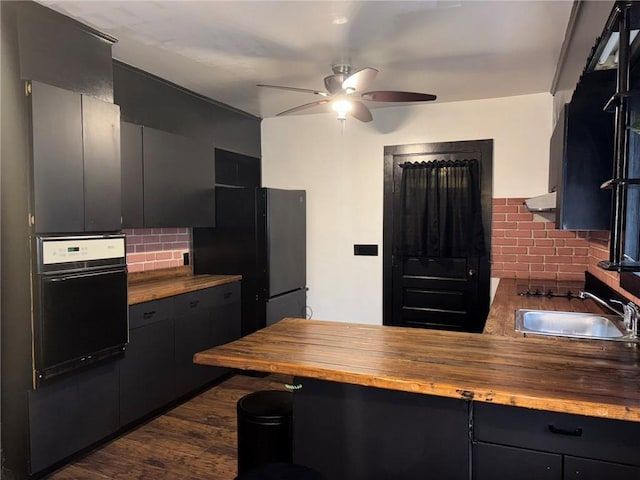 92 Abbott St, Rochester, NY 14606 - kitchen featuring wood counters, oven, backsplash, freestanding refrigerator, and a ceiling fan