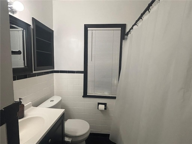 92 Abbott St, Rochester, NY 14606 - full bath featuring tile walls, vanity, curtained shower, and a wainscoted wall