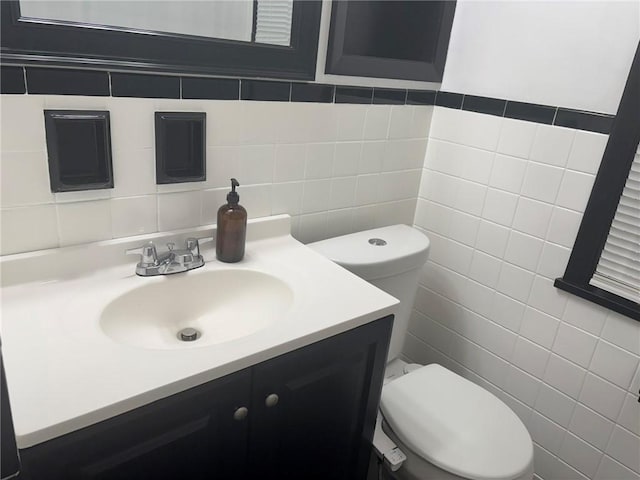 92 Abbott St, Rochester, NY 14606 - half bathroom featuring tile walls, vanity, and tasteful backsplash