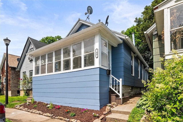 69 Diem St, Rochester, NY 14620 - view of home's exterior with a sunroom